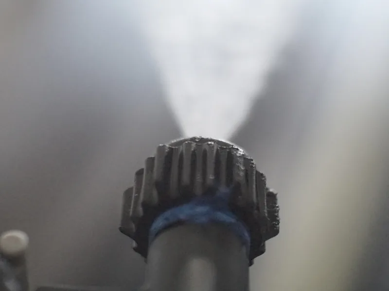 High-pressure rinse spraying down a car in the wash tunnel
