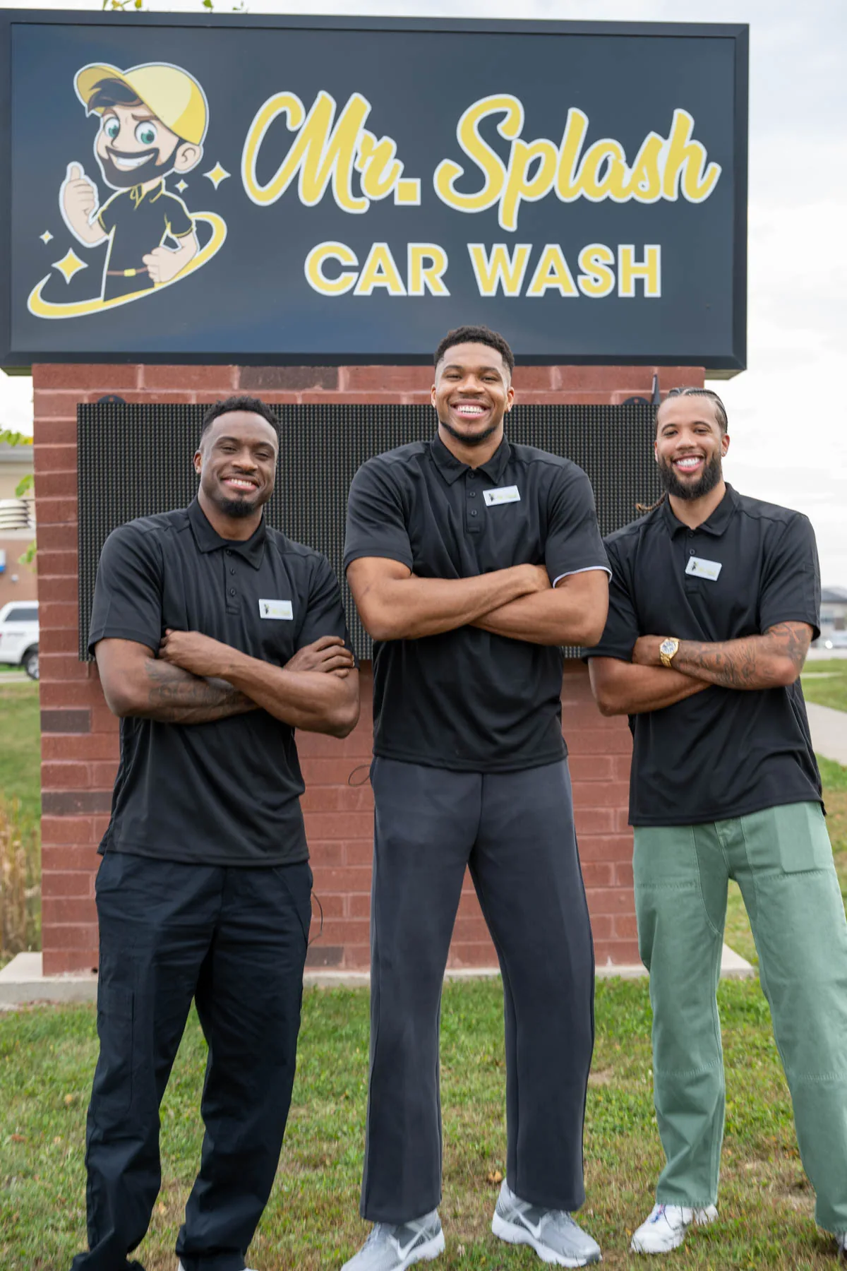 The Splash Squad investor-partners in Mr. Splash polos in front of the Mr. Splash Car Wash sign